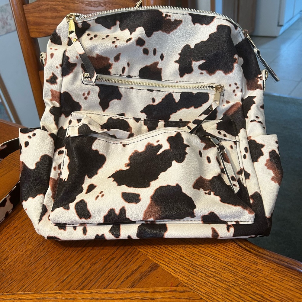 Chic Cow Print Backpack with Gold Details